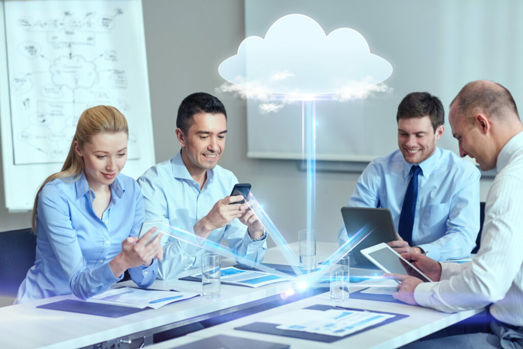 Smiling employees connect to the cloud while at work. 