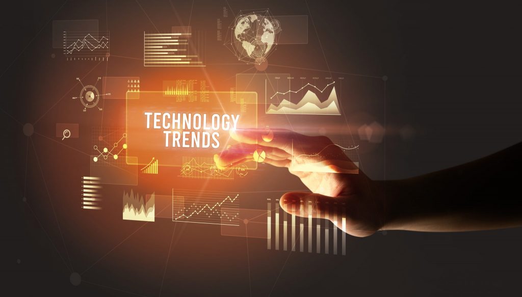 Hand pointing to icons with the word "technology trends" in orange.