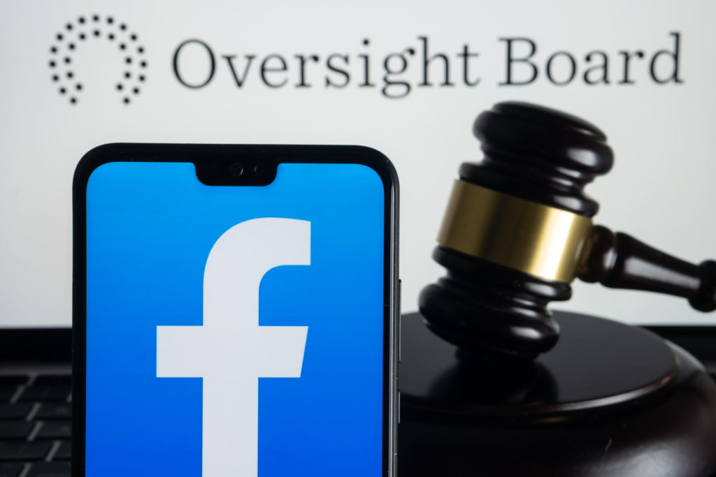  Phone with facebook open in front of a gavel. 