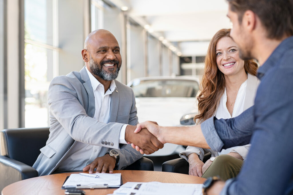 Insurance agent shakes hands with client after getting Condo Directors and Officers Insurance.