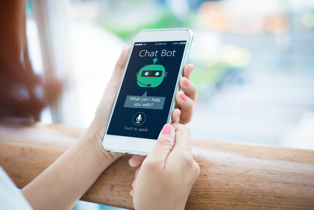  Image of woman getting customer assistance from a chatbot via her smartphone. 