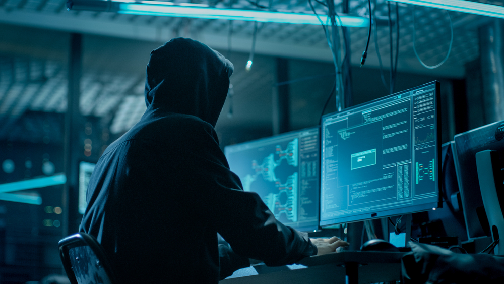 Hooded hacker attempts to exploit a company's unpatched vulnerabilities. 